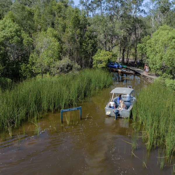 a boat parked on the side of a river