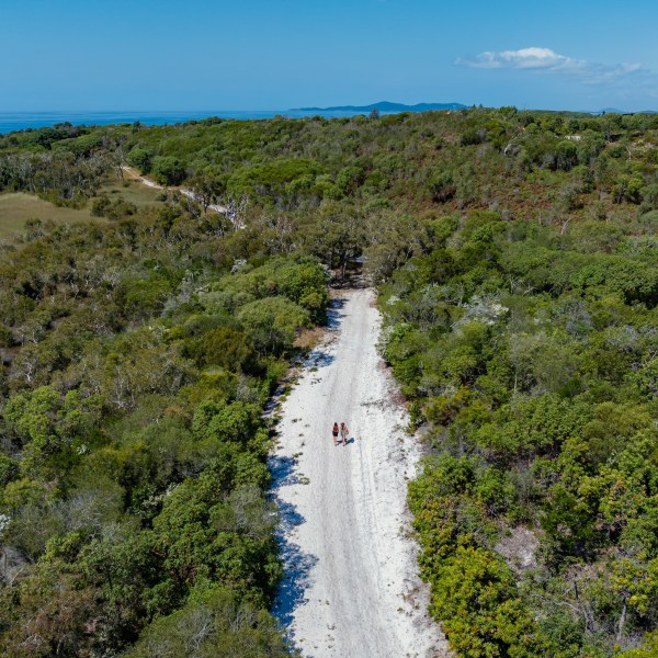 a sign on the side of a river