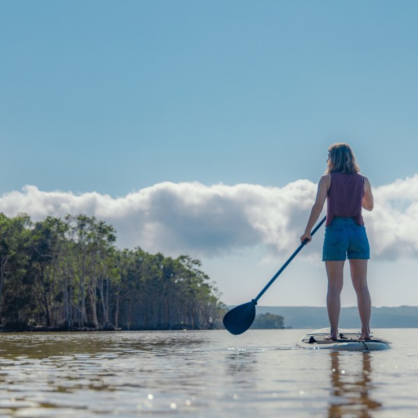a person standing next to a body of water